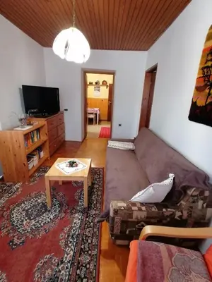 a living room with a couch and a table at Apartma Tilika in Kranjska Gora