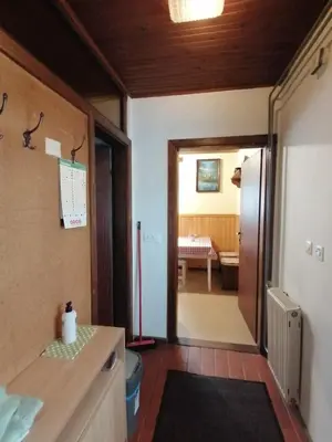 a kitchen with a door leading to a dining room at Apartma Tilika in Kranjska Gora