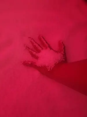a pink felt handprint on a red blanket at 47 Heaven Luxury House in Radovljica