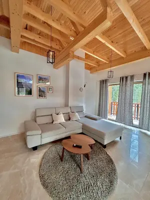 a living room with a couch and a table at ALPS Apartments in Kranjska Gora