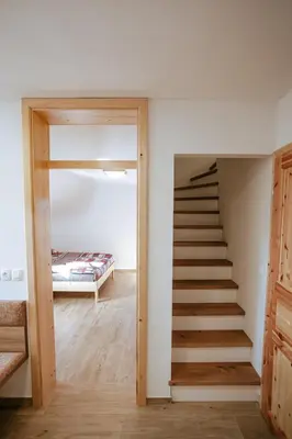 a staircase leading to a bedroom with a bed at Apartments Čenda in Železniki