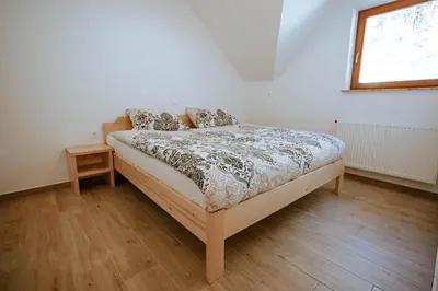 a bedroom with a bed and a window at Apartments Čenda in Železniki
