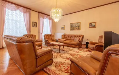 a living room with leather furniture and a chandelier at Beautiful Home In Obrov in Obrov