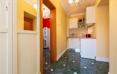 a kitchen with yellow walls and white cabinets at Beautiful Home In Obrov in Obrov