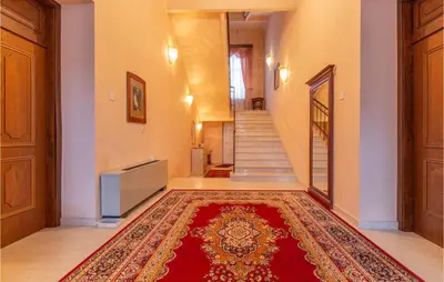 a hallway with a red rug on the floor at Beautiful Home In Obrov in Obrov