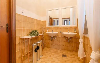 a bathroom with two sinks and a mirror at Beautiful Home In Obrov in Obrov