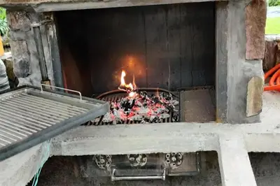 a stone oven with a fire in it at Apartment Sofia in Idrija