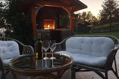 a table with two wine glasses and a fireplace at Apartment Sofia in Idrija