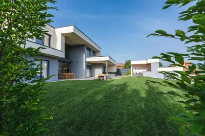 a view of a house with a green yard at HIRUNDO- villa with saunas and hot tub in Sela pri Dobovi