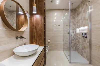 a bathroom with a sink and a shower at HIRUNDO- villa with saunas and hot tub in Sela pri Dobovi