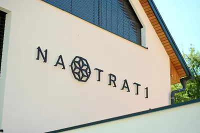 a sign on the side of a building at Na trati Pension in Črna na Koroškem
