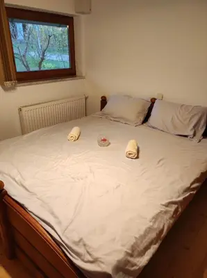 a bed with two hats on top of it at Turistična kmetija Štupar in Dvor