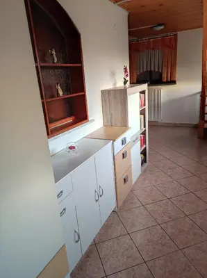 a kitchen with white cabinets and a tile floor at Turistična kmetija Štupar in Dvor