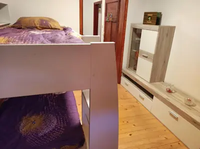 a bedroom with a bunk bed and a dresser at Turistična kmetija Štupar in Dvor