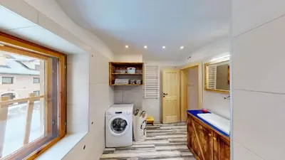 a bathroom with a washing machine and a window at hiša Margit, Rateče 150 in Rateče