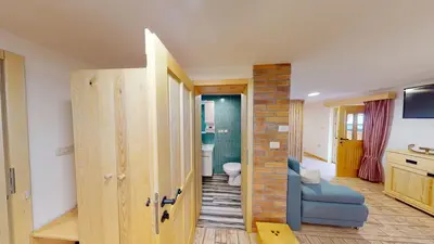 a living room with a door and a bathroom at hiša Margit, Rateče 150 in Rateče
