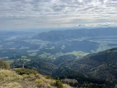 a view of a valley from the top of a mountain at Primorka Golte in Mozirje
