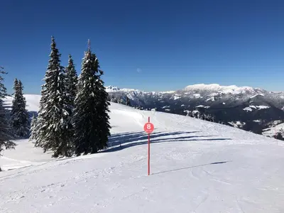 a sign in the snow on a ski slope at Primorka Golte in Mozirje