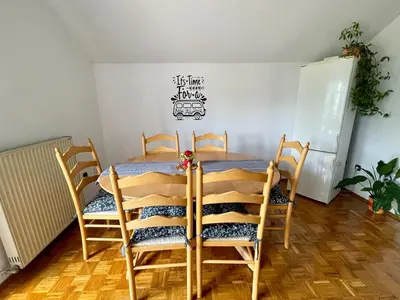 a dining room with a table and chairs at Prijeten prostoren apartma v hiši in Pivka