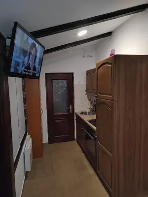 a kitchen with a flat screen tv on the wall at E79 AQUALUNA KAMP NATURA PODČETRTEK card not included in Podčetrtek