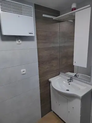 a bathroom with a white sink and a mirror at E79 AQUALUNA KAMP NATURA PODČETRTEK card not included in Podčetrtek