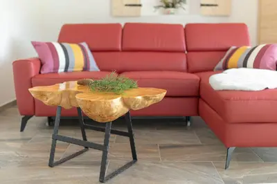 a living room with a red couch and a table at Holiday House Vikend in Polzela