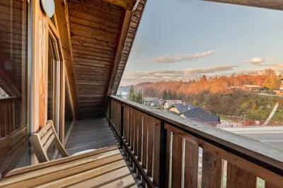 a balcony of a cabin with a view of a town at Svisla in Kranj