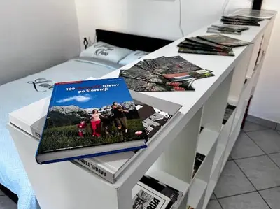 a white table with a book on top of it at Apartma B & O in Idrija