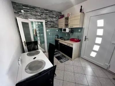 a small kitchen with a sink and a counter at Apartma B & O in Idrija