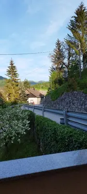 a view of a yard with a fence and flowers at Apartma B & O in Idrija