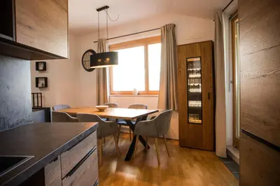 a kitchen with a table and chairs and a window at Apartment - Golden Fox 18 - Pohorske terase in Pohorje