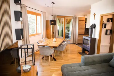 a living room with a wooden table and a couch at Apartment - Golden Fox 18 - Pohorske terase in Pohorje