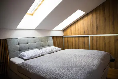 a bedroom with a bed and a skylight at Apartment - Golden Fox 18 - Pohorske terase in Pohorje
