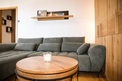 a living room with a couch and a coffee table at Apartment - Golden Fox 18 - Pohorske terase in Pohorje