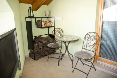 a room with two chairs and a table and a shelf at Apartment - Golden Fox 18 - Pohorske terase in Pohorje
