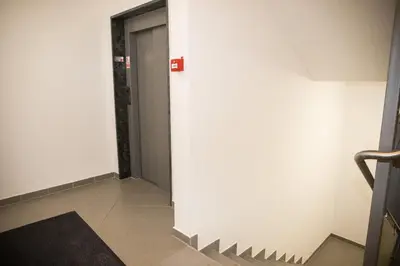 a hallway with a white wall and a door at Apartment - Golden Fox 18 - Pohorske terase in Pohorje