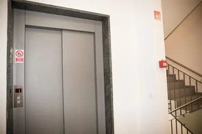 an elevator door in a building with stairs at Apartment - Golden Fox 18 - Pohorske terase in Pohorje