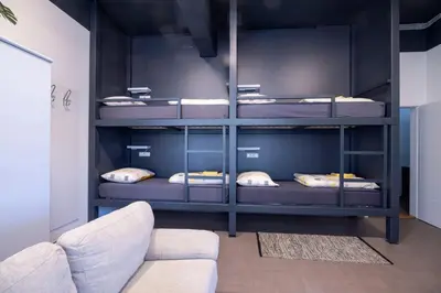 a room with four bunk beds with pillows at Hostel Veronika Celje in Celje