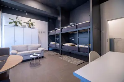 a room with a couch and two bunk beds at Hostel Veronika Celje in Celje