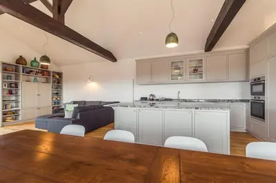 a kitchen and living room with a couch and a table at Cherry Orchard House in Šmartno