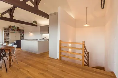 a kitchen and living room with a table and a dining room at Cherry Orchard House in Šmartno