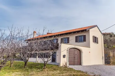 a large white house with a garage at Cherry Orchard House in Šmartno