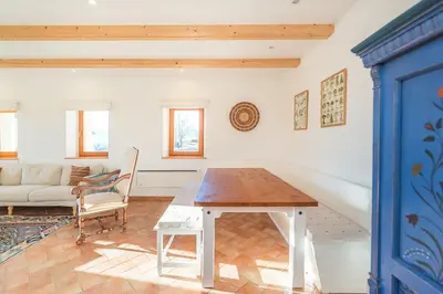 a living room with a table and a couch at Dandelion House in Podjelje