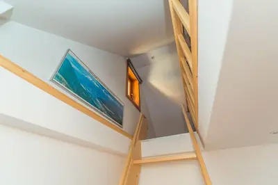 a staircase in a house with two paintings on the wall at Dandelion House in Podjelje