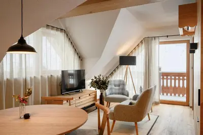 a living room with a table and a tv at Vila Pavlina in Kranjska Gora