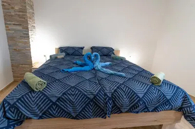 a blue bed with a blue ribbon on it at Apartma Valič in Ajdovščina