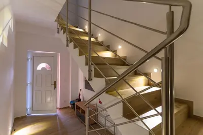 a spiral staircase in a house with a white door at Apartma Valič in Ajdovščina
