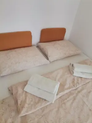 two beds in a room with towels on them at Ela Apartments - 1 in Kranjska Gora