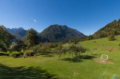 a green field with a soccer ball in the grass at Ela Apartments - 1 in Kranjska Gora