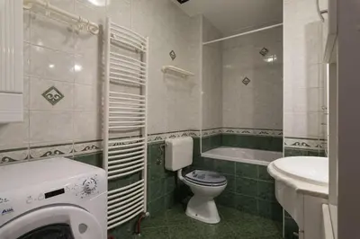 a bathroom with a toilet and a sink and a tub at Ela Apartments - 1 in Kranjska Gora